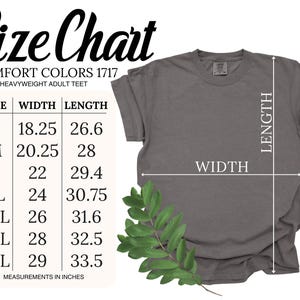 May include: A gray Comfort Colors 1717 heavyweight adult tee shirt with a size chart. The size chart shows the width and length measurements in inches for sizes S through 4XL. A green leafy sprig is in the lower left corner.