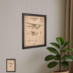 May include: Framed print of a Cessna 172 airplane schematic. The print, measuring 13.78 x 17.72 inches, features detailed illustrations and technical data. The artwork is encased in a black frame, suitable for aviation enthusiasts.