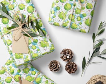 May include: Gift-wrapped presents with tennis ball pattern. The gifts are wrapped in paper with a repeating pattern of green tennis balls and blue watercolor splashes. They are tied with twine and decorated with pine cones and olive branches.