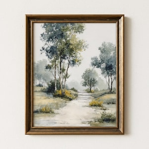May include: A framed watercolor painting of a serene landscape. The artwork depicts a path winding through a misty forest with trees in shades of green and gray. The frame is a warm, golden brown.