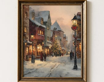 May include: A framed watercolor painting of a snowy Christmas scene. The artwork depicts a street lined with buildings, lit by street lamps and shop windows. A Christmas tree stands in the distance, and figures walk along the snow-covered street.