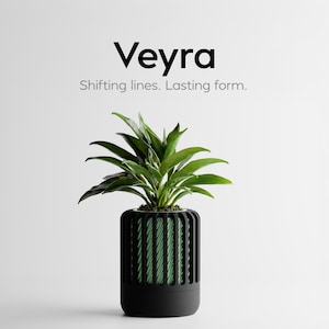 Könnte beinhalten: Ein moderner schwarzer Pflanzentopf mit einer grünen Pflanze. Der Topf hat eine zylindrische Form mit vertikalen Linien und einem grünen Innenraum. Das Bild enthält den Text "Veyra" und den Slogan "Shifting lines. Lasting form."