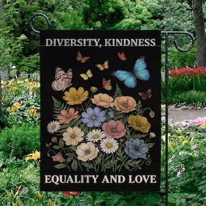 May include: A black garden flag with the words "DIVERSITY, KINDNESS" and "EQUALITY AND LOVE" in white. The flag features colorful flowers and butterflies in shades of yellow, pink, blue, and orange.