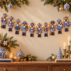 May include: A decorative garland featuring ten nutcracker figures in blue and white porcelain-style patterns, strung together with white beads. Each nutcracker displays unique details like lanterns, instruments, or gifts, creating a cohesive holiday display.