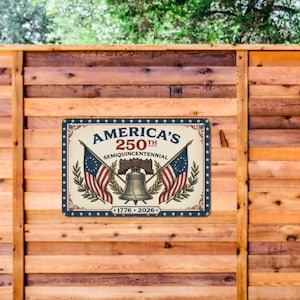 May include: A rectangular metal sign with a patriotic design. The sign features the text "America's 250th Semiquincentennial" with the years 1776-2026. It includes illustrations of American flags and the Liberty Bell, with a blue and red color scheme.