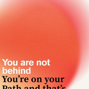 May include: An abstract design with a gradient of orange and red hues. White text reads "You are not behind, You're on your Path and that's Beautiful". The background has a soft, blurred effect.