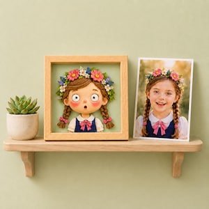 May include: A wooden shelf displays a framed cartoon girl with a flower crown and a photograph of a girl with a similar flower crown. A small succulent plant in a white pot is also on the shelf.