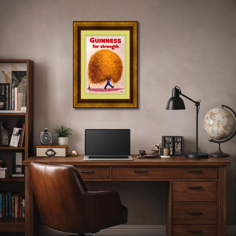 May include: Framed vintage Guinness advertisement. The artwork features a man in a blue suit carrying a large, brown, fluffy object. The text "Guinness for strength" is displayed in red letters at the top of the image.