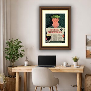 May include: Framed vintage Guinness advertisement featuring a man in a green cap reading a newspaper with the text "Evening Guinness." The illustration includes a pint of Guinness and a green background.