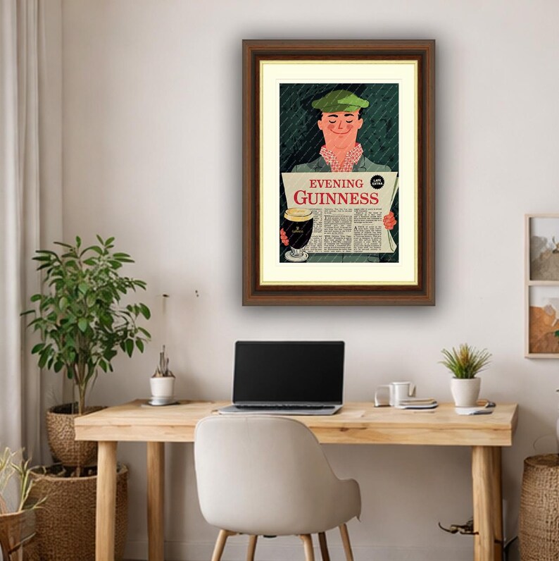 May include: Framed vintage Guinness advertisement featuring a man in a green cap reading a newspaper with the text "Evening Guinness." The illustration includes a pint of Guinness and a green background.