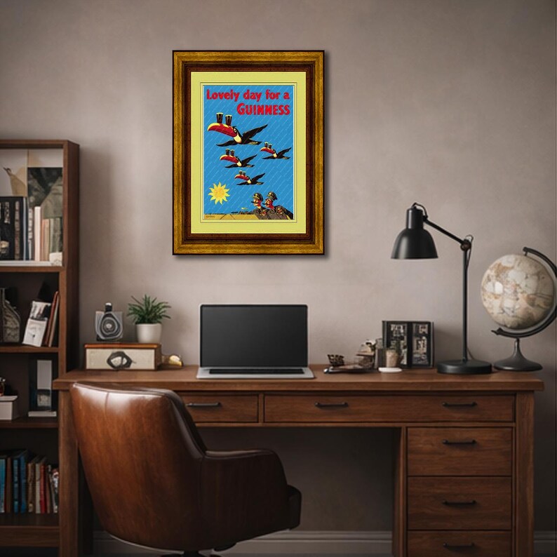 May include: A framed vintage Guinness advertisement. The artwork features toucans flying across a blue sky, each wearing a Guinness pint hat. The text at the top reads "Lovely day for a Guinness."