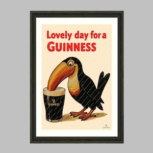 May include: Framed wall art print featuring a cartoon toucan with a large orange beak, drinking from a pint of Guinness. The text "Lovely day for a Guinness" is in red. The print is part of "The Wall Art Parlour Collection."
