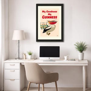 May include: Framed vintage Guinness advertisement featuring a pelican with a red beak and a black and white body. The poster has the text "My Goodness My Guinness" in red and black. The image is in a black frame.