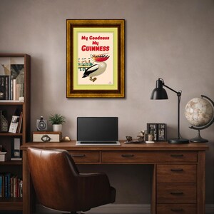 May include: Framed vintage advertisement for Guinness stout. The artwork features a pelican with a red beak and a boat filled with people. The text reads "My Goodness My Guinness" in red and white.