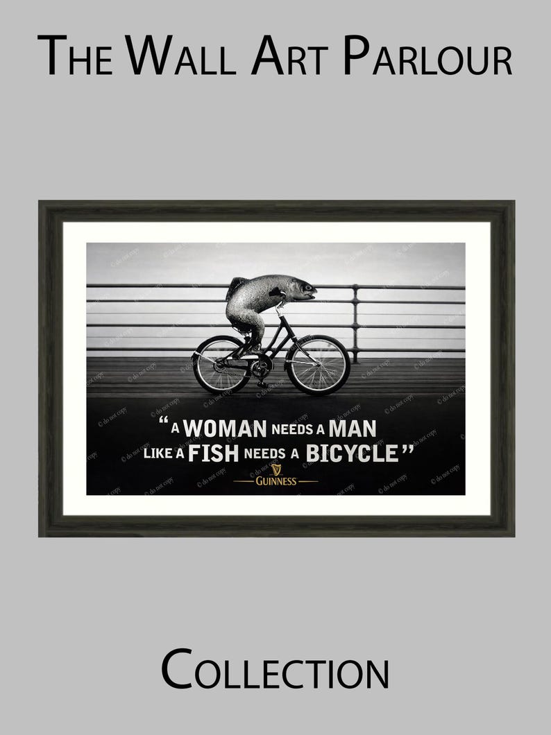May include: Black and white framed wall art print. The image features a fish riding a bicycle with the quote "A woman needs a man like a fish needs a bicycle." The Guinness logo is at the bottom.