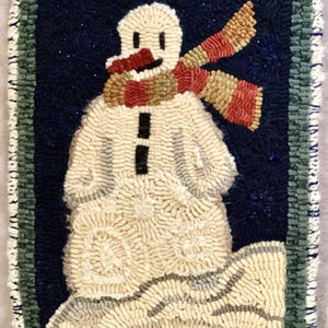 May include: Hand-hooked rug featuring a snowman with a red and tan scarf, black coal buttons, and a carrot nose. The snowman is set against a dark blue background with a green border. The rug is rectangular.