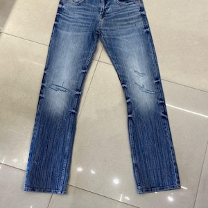 ligth faded blue jeans with little bit rugged
