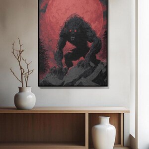 May include: A framed art print depicting a werewolf with glowing red eyes, set against a blood-red moon. The creature is on a rocky surface, with dark trees in the background. The artwork is in shades of black, grey, and red.