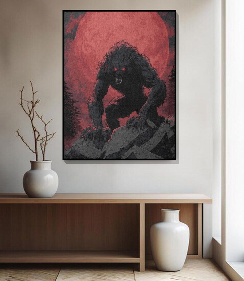 May include: A framed art print depicting a werewolf with glowing red eyes, set against a blood-red moon. The creature is on a rocky surface, with dark trees in the background. The artwork is in shades of black, grey, and red.