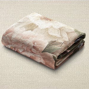 May include: Folded floral fabric with a peony design in pink, white, and green. The fabric is folded neatly, displaying the detailed print of the flower and leaves. The folded fabric is on a neutral background.