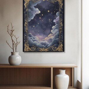 May include: A framed artwork depicting a night sky scene with clouds, stars, and a decorative gold border. The painting features a dark blue and purple color palette, creating a dreamy and celestial atmosphere. The artwork is displayed on a wall above a wooden console.