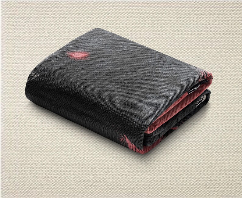 May include: Folded black wallet with a textured surface. The interior and edges are a contrasting pink colour. The wallet appears to be made of a durable material.