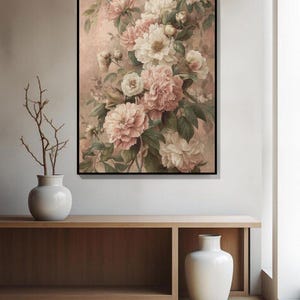 May include: A framed floral print showing a bouquet of pink and cream peonies with green leaves against a muted pink backdrop. The artwork is above a wooden console with a white vase and decorative branches.
