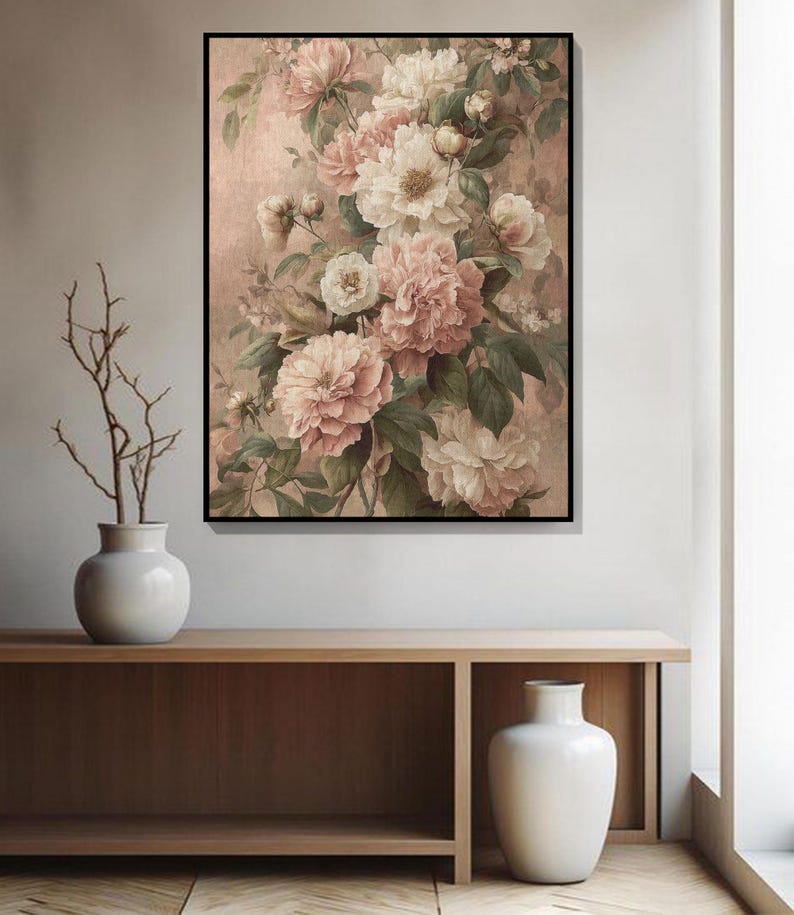 May include: A framed floral print showing a bouquet of pink and cream peonies with green leaves against a muted pink backdrop. The artwork is above a wooden console with a white vase and decorative branches.