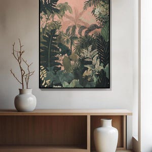 May include: A framed botanical print depicting a dense jungle scene with diverse green foliage and palm trees set against a pale pink backdrop. The artwork is displayed above a wooden console with two white vases.
