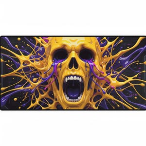 May include: A rectangular desk mat with a screaming yellow skull design. The skull has an open mouth and exposed teeth, with purple and yellow paint splashes against a black background. The design is a vibrant and artistic representation.