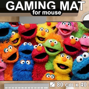 May include: A gaming mouse pad featuring a colorful collage of Sesame Street characters. The pad is rectangular, with dimensions of 80 cm x 40 cm, and includes the text "GAMING MAT for mouse". The pad has durable stitching.