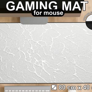 May include: White gaming mat for mouse with a textured surface. The mat has the text "GAMING MAT for mouse" at the top. The mat measures 80 cm x 40 cm, with durable stitching.