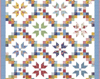 May include: A patchwork quilt with a white background and a repeating pattern of colorful starbursts and geometric shapes. The quilt features a variety of floral and patterned fabrics in shades of red, blue, yellow, and green, with a blue border.