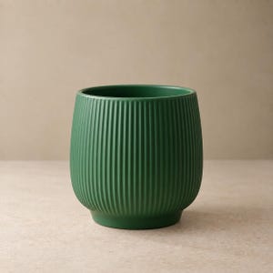 May include: A dark green ceramic planter with a rounded, bulbous shape and a vertical ribbed texture. The vessel features a smooth matte finish, a wide circular opening at the top, and a slightly recessed base, creating a clean and uniform appearance.