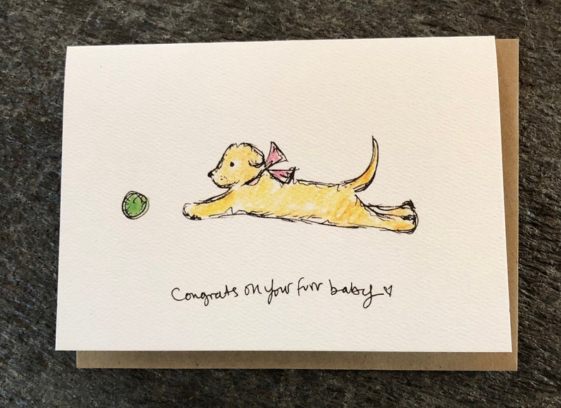 Happy Puppy with pink bow playing with green ball