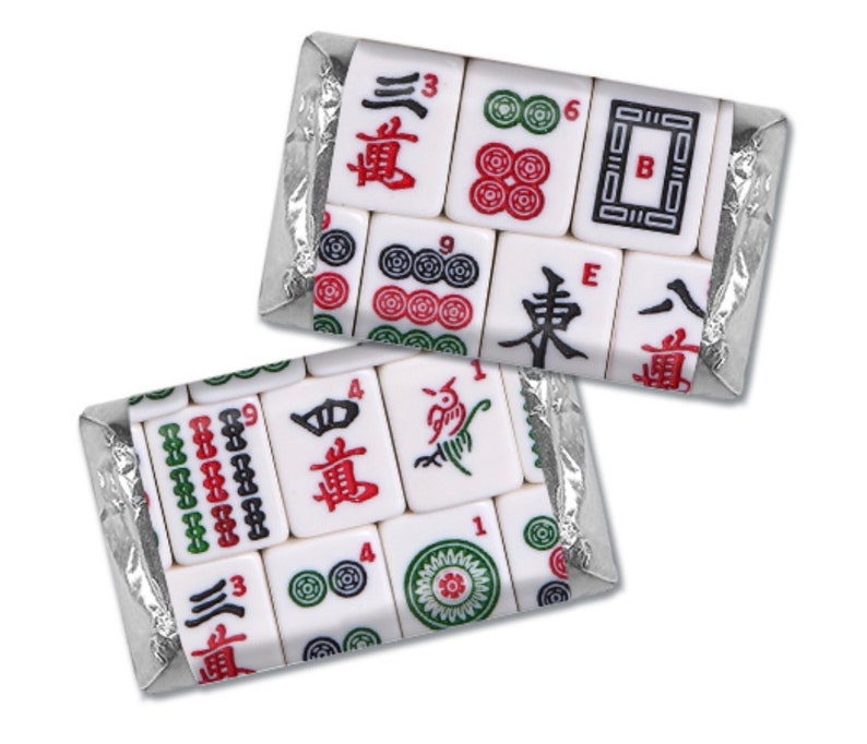 May include: Two sealed packages of Mahjong tiles. The white tiles feature red, green, and black symbols and numbers. The tiles are packaged in clear plastic with a silver foil backing. The game pieces are for the popular tile-based game.