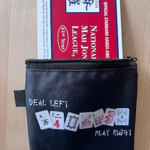 Mahjongg Coin Purse fits money and small card says deal left play right, color is Black