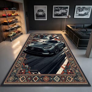May include: A rectangular area rug featuring a central graphic of a dark gray Mercedes-Benz sports car in motion, surrounded by a decorative border with geometric patterns in shades of orange, teal, and cream on a dark background.