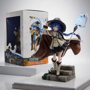 May include: A Roxy Migurdia anime figure, featuring a character with blue hair, a black hat, and a brown cape. The figure holds a staff with a glowing blue tip and stands on a stone staircase. The box is visible in the background.