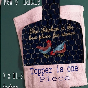 May include: A blue and gold quilted pot holder with a chicken design and the text "The Kitchen is the best place for stories". The pot holder is 7 inches by 11.5 inches and has a 6 inch handle. The pot holder is made of one piece.