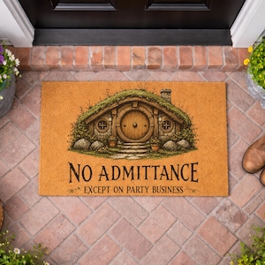 May include: A rectangular tan coir doormat featuring a printed illustration of a round-doored earth-sheltered house with a grass roof. The text "NO ADMITTANCE EXCEPT ON PARTY BUSINESS" is printed in black lettering below the house illustration.