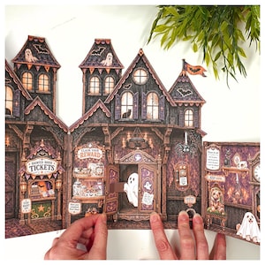 May include: A multi-paneled paper craft haunted house display featuring dark wood textures, orange accents, and various Halloween illustrations. The scene includes a ticket booth, a ghost emerging from a cupboard, a spider, and text reading Haunted House Tickets, Claim Your Reward, and Emergency Exit.