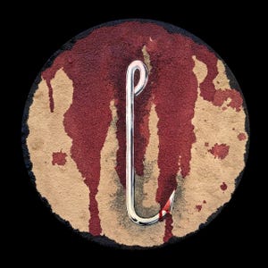 May include: A silver fishing hook with a red-stained tip is centered on a circular, textured, tan and maroon surface. The surface has a black border and is set against a black background. The maroon color appears to be dripping down the tan surface.