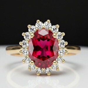 May include: A gold ring featuring a large, oval-cut ruby gemstone surrounded by a halo of small, round diamonds. The ruby is a deep red color, and the diamonds sparkle against the gold band.