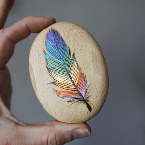 Rainbow Feather Pebble, Pyrography on solid wood with metallic paints