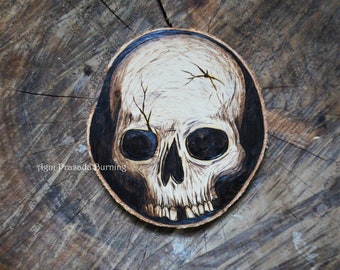Skull art pyrography gothic hanging decoration on natural wood slice. Halloween decoration idea