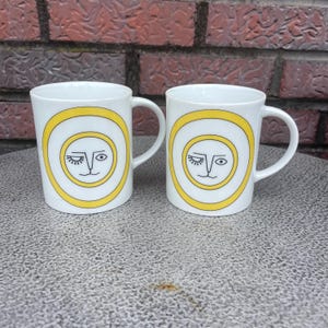 Pair Vintage 60s 70s Sigma Taste Setter Winking Eye Sun Lion MCM Coffee Mug Tea Cup Set of Two
