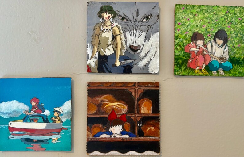 May include: Five square paintings depicting scenes from animated films. One shows a woman with a wolf, another shows two children in a field, a third shows a boat on the water, a fourth shows a girl in a bakery, and the last shows two children.