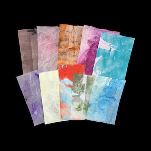 May include: A collection of ten rectangular sheets of textured paper, each featuring unique watercolor-style patterns in various colors including brown, pink, orange, purple, yellow, red, green, and multiple shades of blue, arranged in a fan.