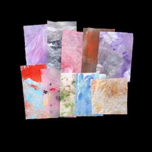 May include: A collection of rectangular paper sheets featuring various abstract patterns and colors, including shades of purple, pink, blue, green, orange, and brown. The papers have a textured, semi-translucent appearance with visible fibers.